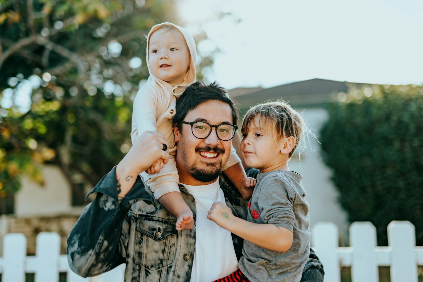 Arjun outdoors with his two children